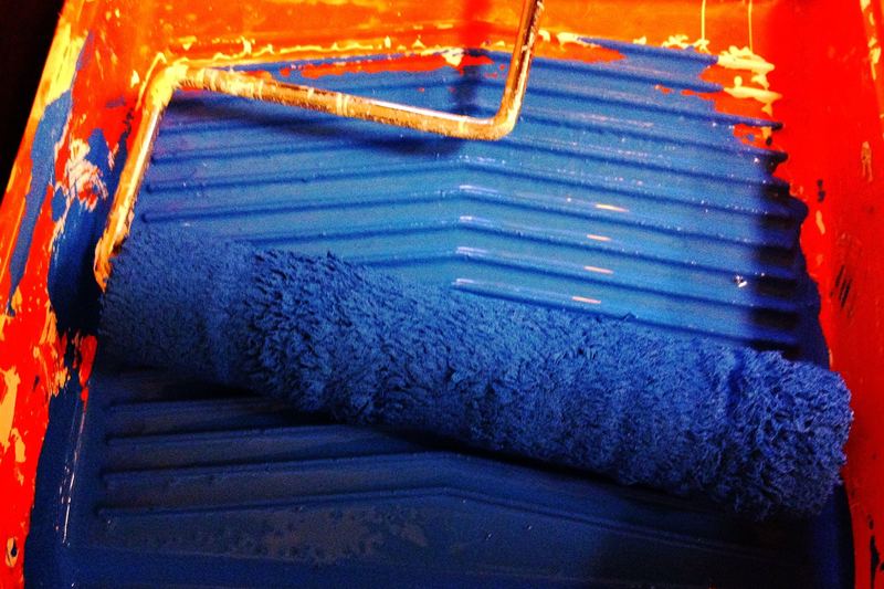 Blue paint roller on a surface